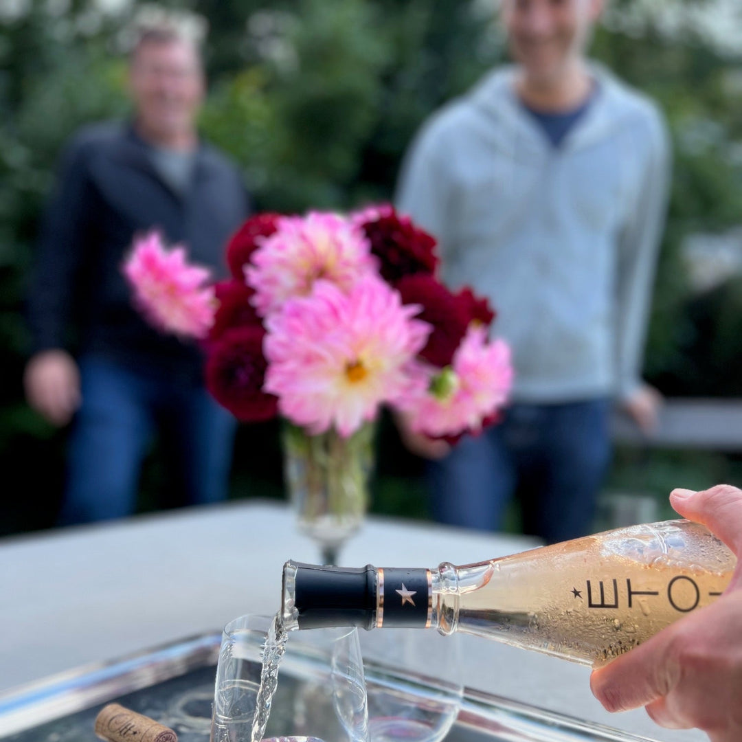 A bottle of rose being poured